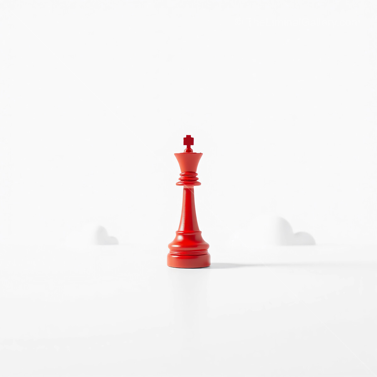 Red chess king stands tall against a minimalist white backdrop in a quiet moment